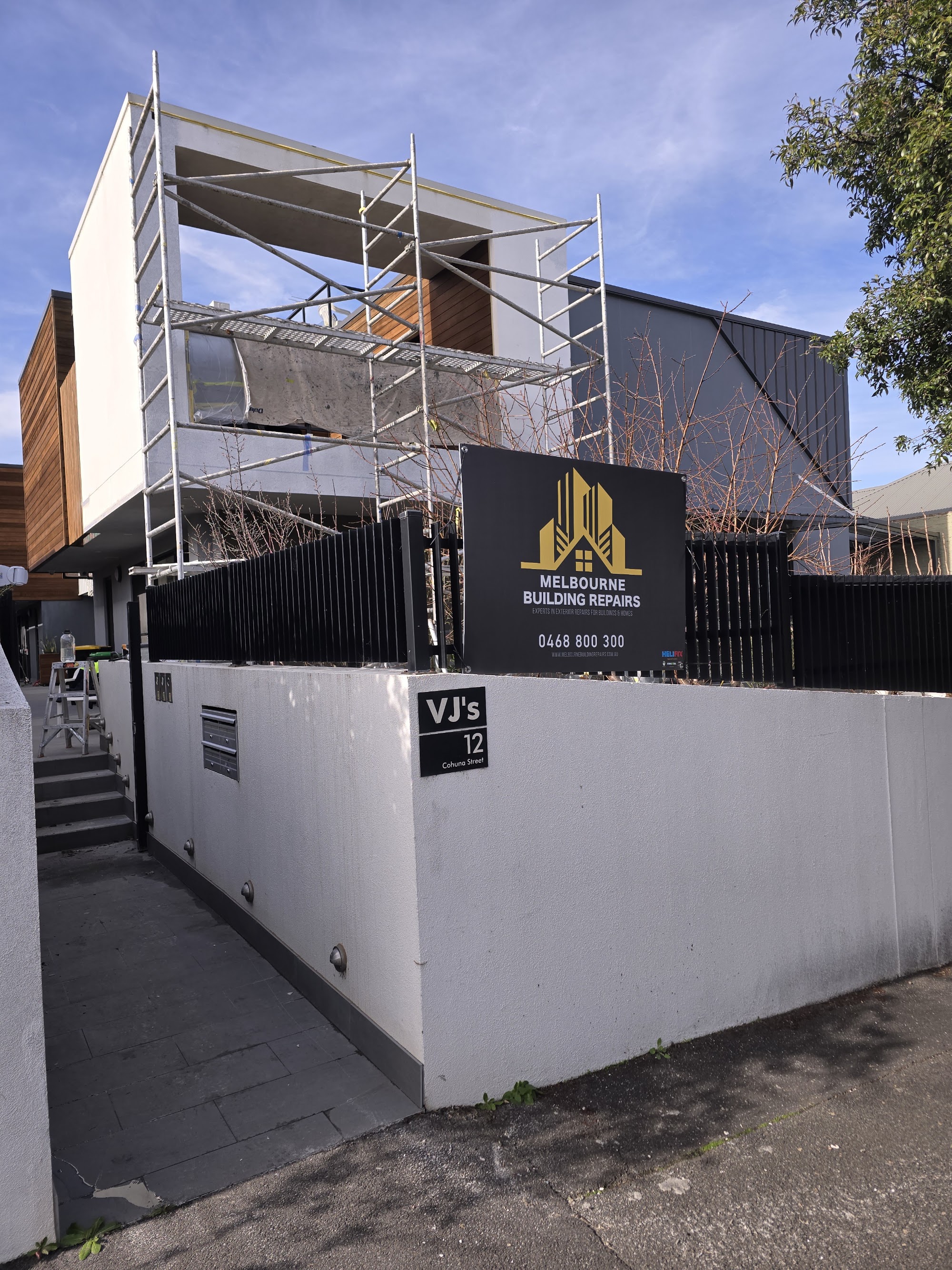 Melbourne Building Repairs site signage on a scaffolded remedial job